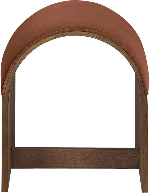 Dark brown velvet upholstered bench end with arched back and dark wood frame