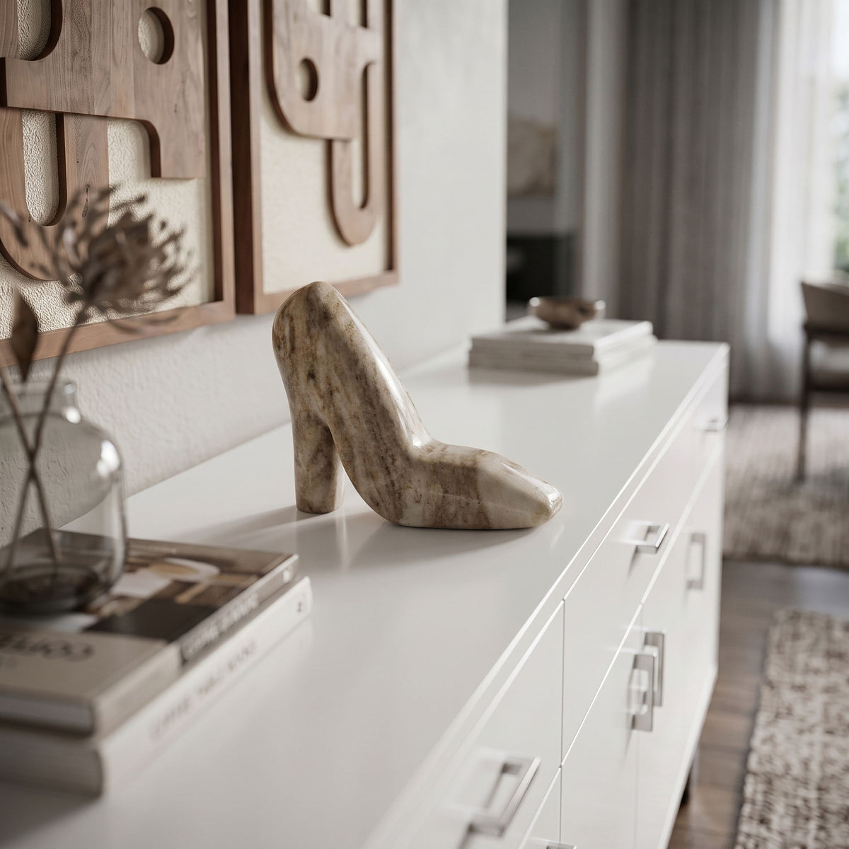 Brown marble high-heel shoe sculpture displayed on a white console