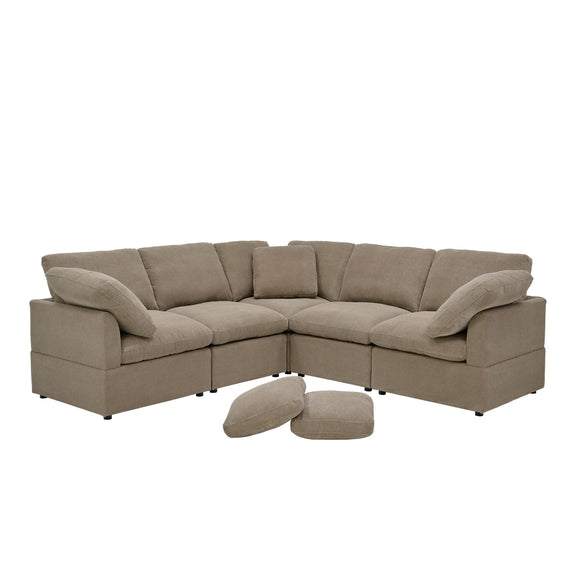 Camel modular L-shaped sofa with plush cushions, wide arms, and two loose pillows.