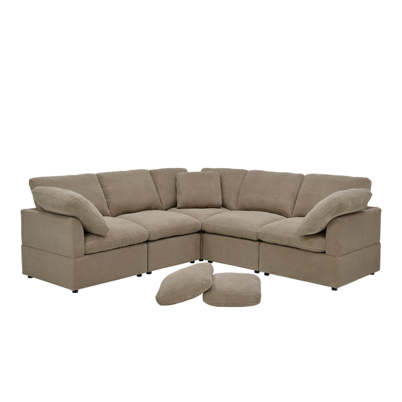Camel modular L-shaped sofa with plush cushions, wide arms, and two loose pillows.