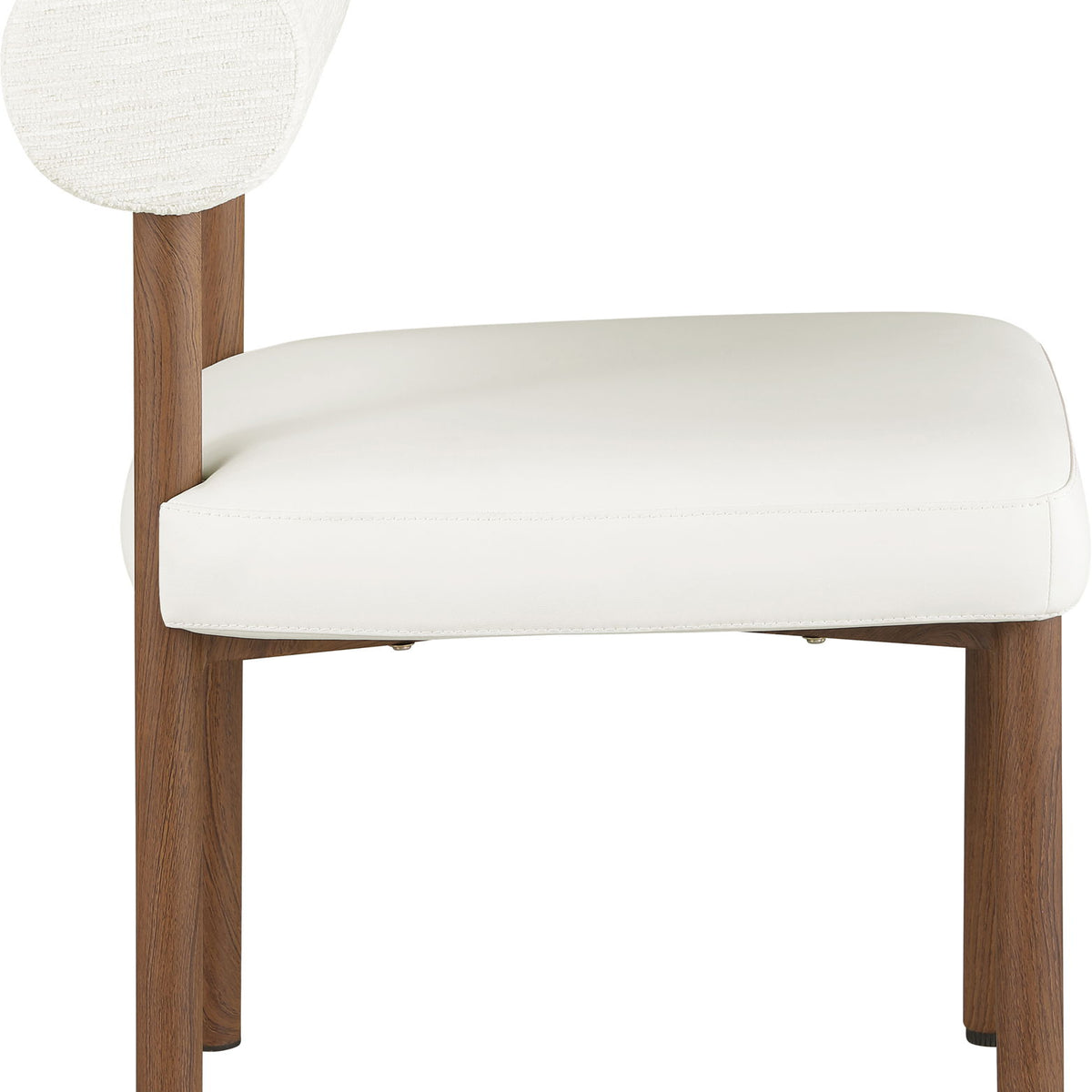White upholstered dining chair with chenille back, vegan leather seat, and tapered wood legs.
