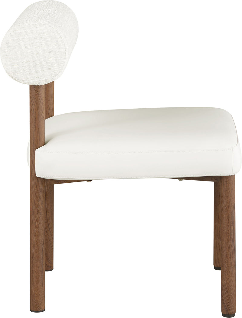 White upholstered dining chair with chenille back, vegan leather seat, and tapered wood legs.