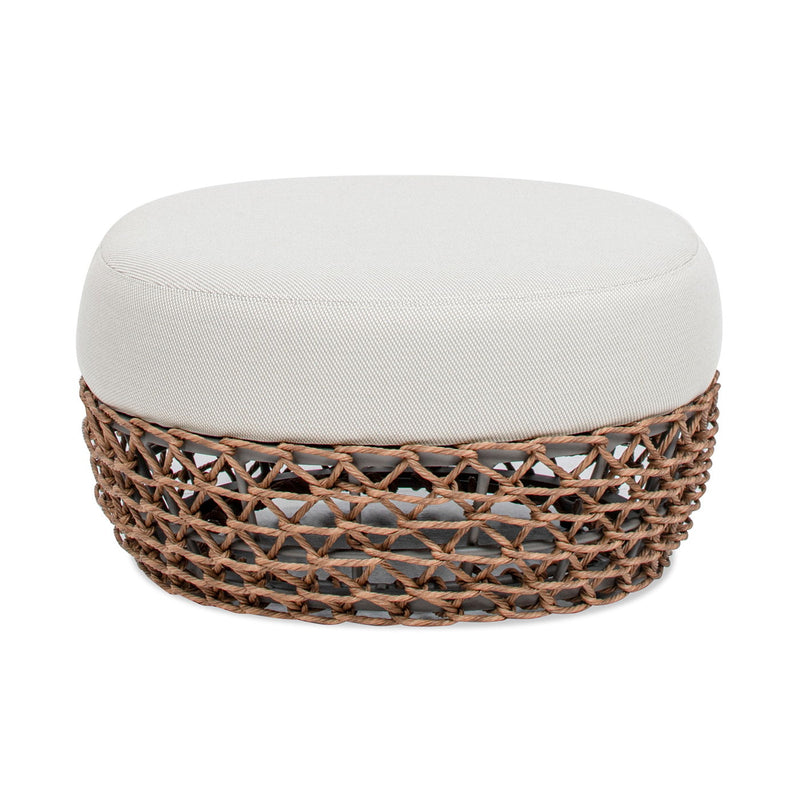 Round upholstered patio ottoman with light beige top and dark woven wicker sides