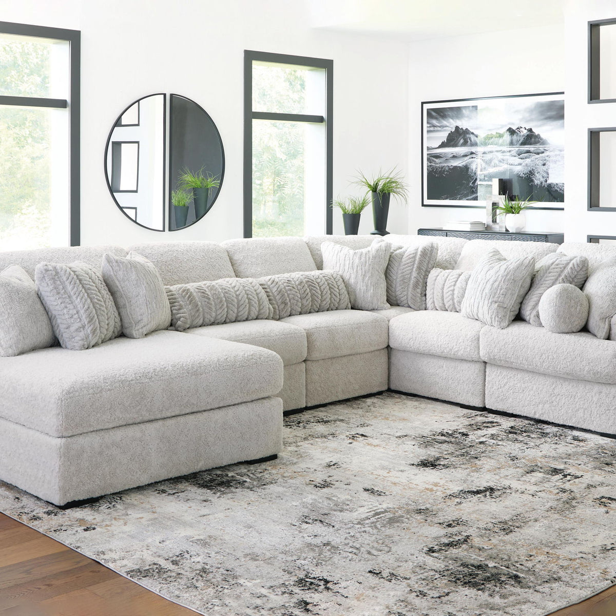 White sectional sofa with chaise corner and multiple throw pillows on plush cushions