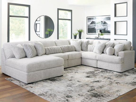White sectional sofa with chaise corner and multiple throw pillows on plush cushions