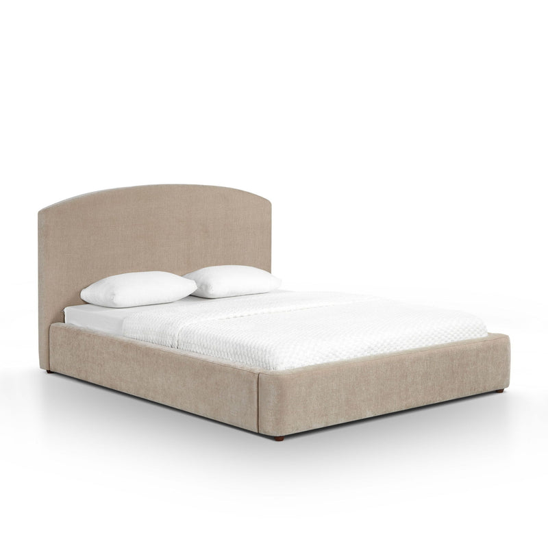 Light brown upholstered bed frame with rounded headboard and white pillows on bed