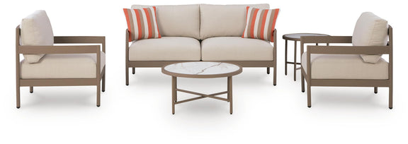 Beige patio loveseat with two lounge chairs and round coffee table