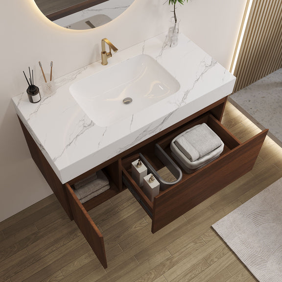 Walnut bathroom vanity with open drawer and cabinet showing storage beside a white basin