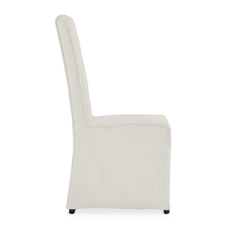 Light white upholstered dining chair with tall back, boxy seat, and tapered legs