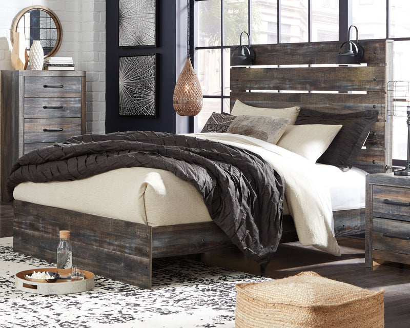 Drystan panel bed with dark wood frame and slatted headboard, styled with layered bedding