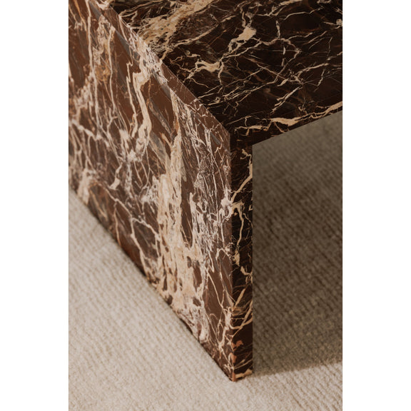 Red-brown marble coffee table leg and edge detail with gold-white veining