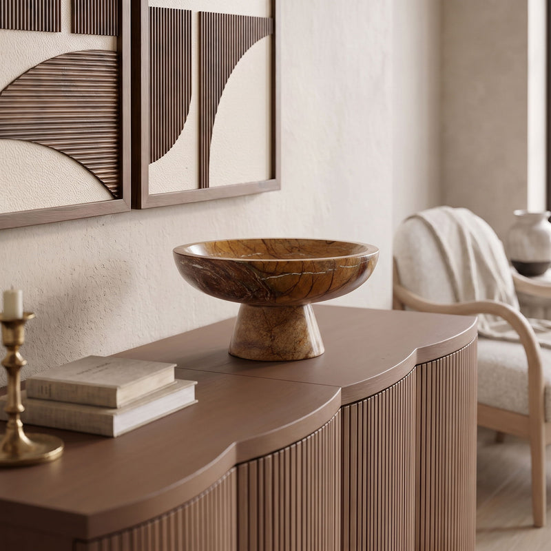 Brown marble pedestal bowl on a console table with carved marbling texture