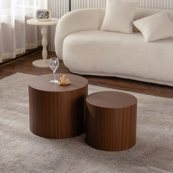 Set of 2 round nesting coffee tables with dark brown wood tops and tapered sides