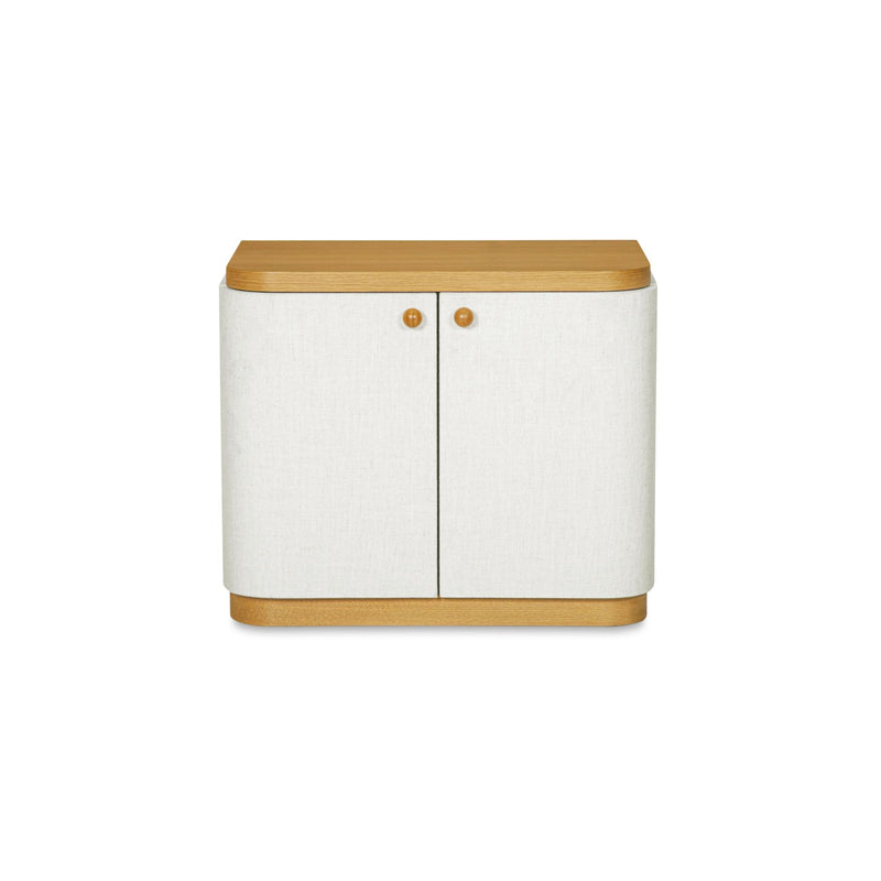 Cream fabric nightstand with curved sides, wood top, two doors and brass knobs