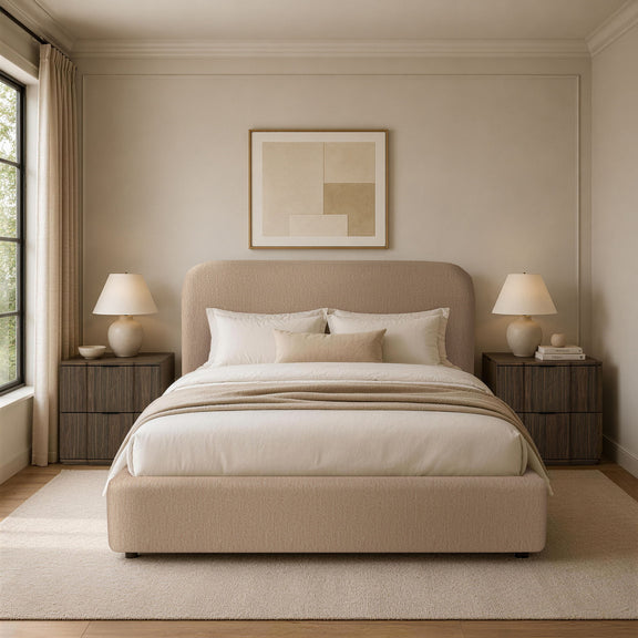 Light brown upholstered bed with rounded headboard and white bedding in a staged bedroom