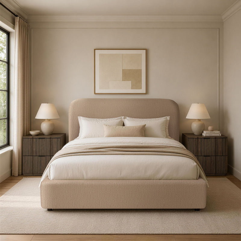 Light brown upholstered bed with rounded headboard and white bedding in a staged bedroom