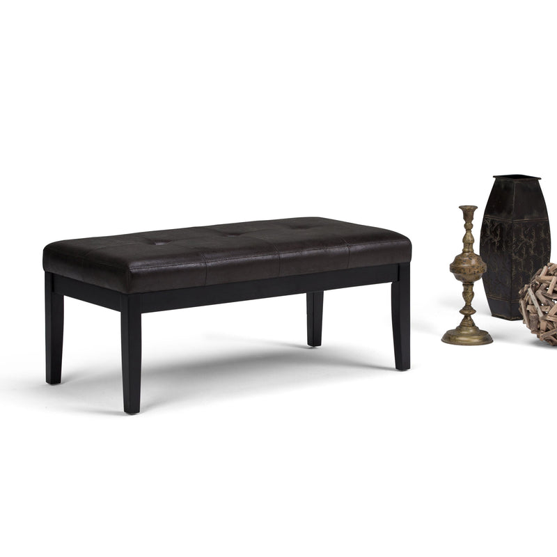Black upholstered tufted ottoman bench with button-style tufting and tapered wooden legs