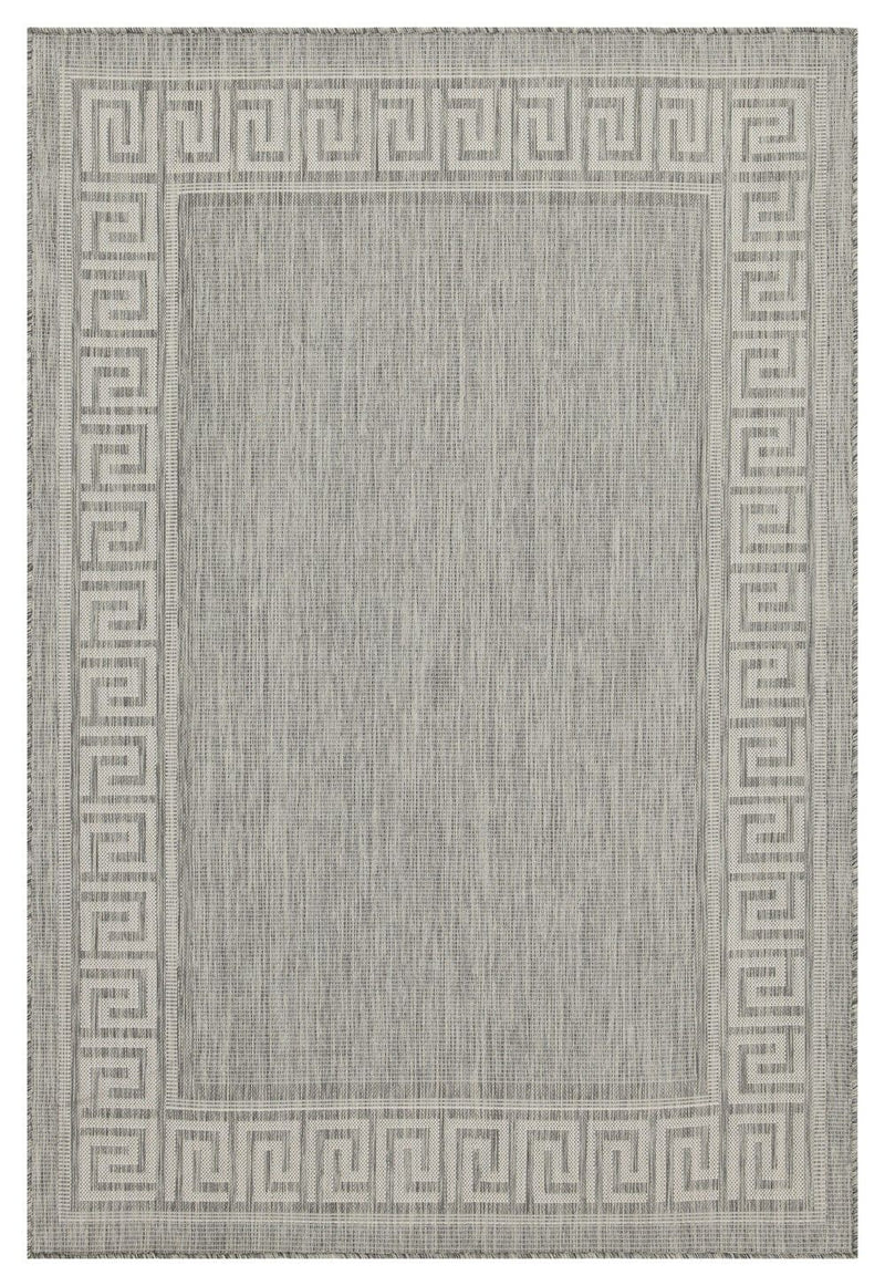 Indoor/outdoor area rug in light gray with Greek key border and textured center