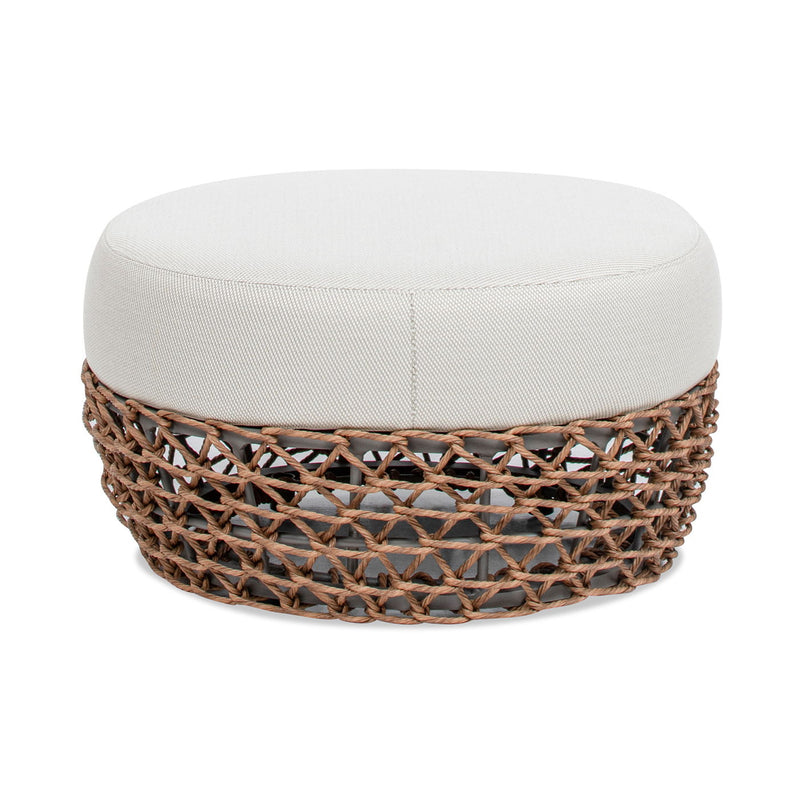 Round upholstered patio ottoman with light beige cushion and dark woven wicker base