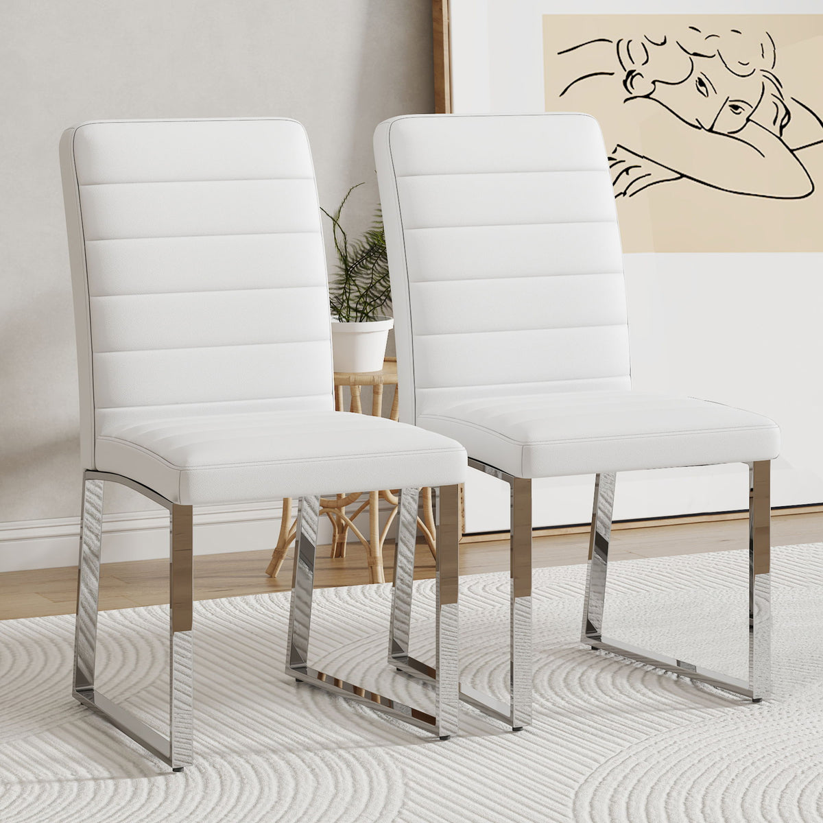 Two white upholstered dining chairs with curved backrests and padded seats