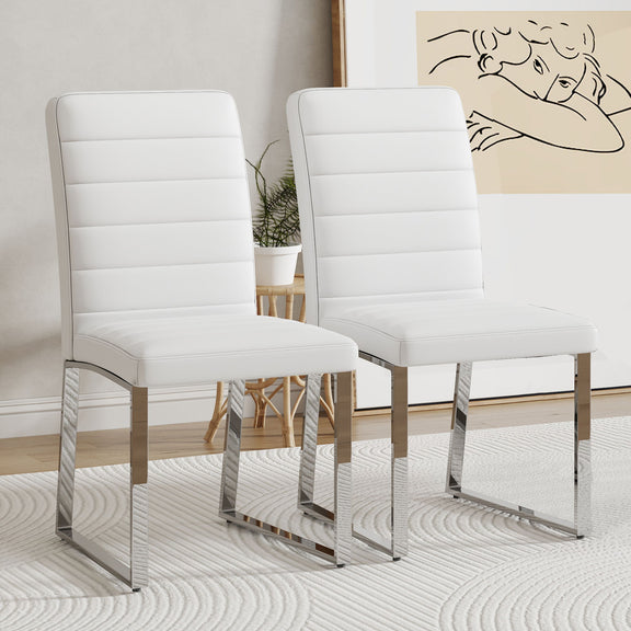 Two white upholstered dining chairs with curved backrests and padded seats