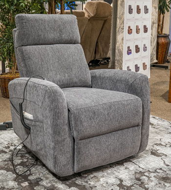 Slate power lift recliner with padded arms, high back, footrest, and wired hand control.