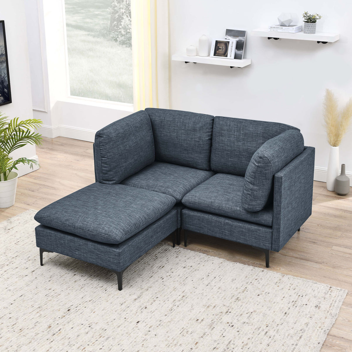 Modular sectional sofa with tall legs, upholstered in medium blue-gray, chaise ottoman