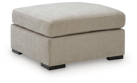 Oversized accent ottoman in light neutral fabric with black feet