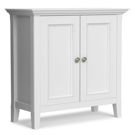 White low storage cabinet with two paneled doors and round metal knob pulls