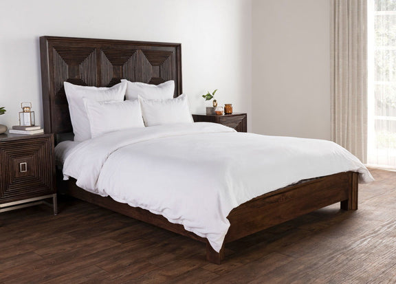 White rectangular pillow shams with subtle stripe texture arranged on a bed