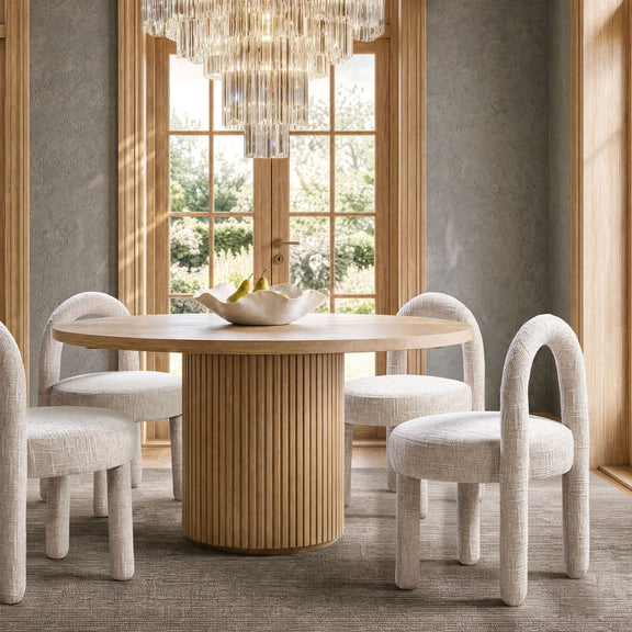 Beige fully upholstered dining side chairs with round-arched backs and curved arms