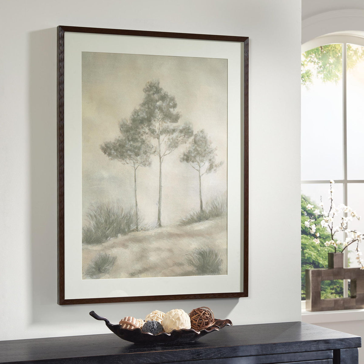 Framed wall art print featuring tall trees in foggy pastel gray and beige