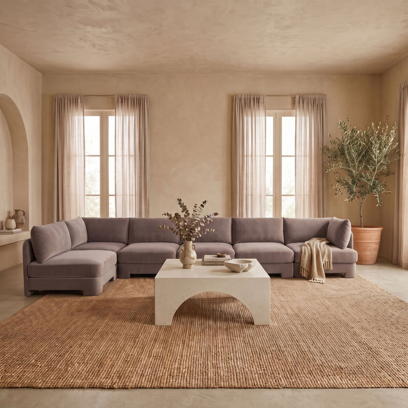 Gray L-shaped armless sectional sofa with velvet-look upholstery and chaise corner