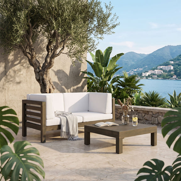 Outdoor love seat and coffee table set with white cushions and dark wood frame