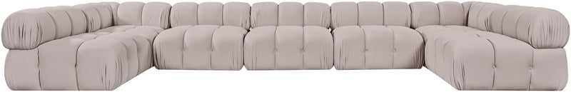 Light gray modular U-shaped sectional sofa with tufted cushions and rounded arm sections