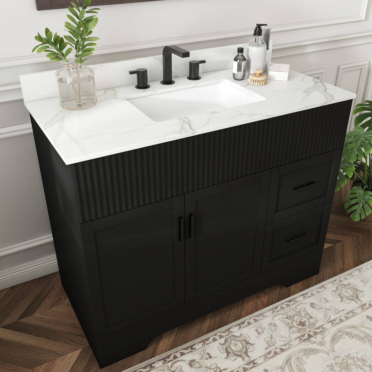 Black bathroom vanity with fluted doors, white countertop sink, three faucet holes