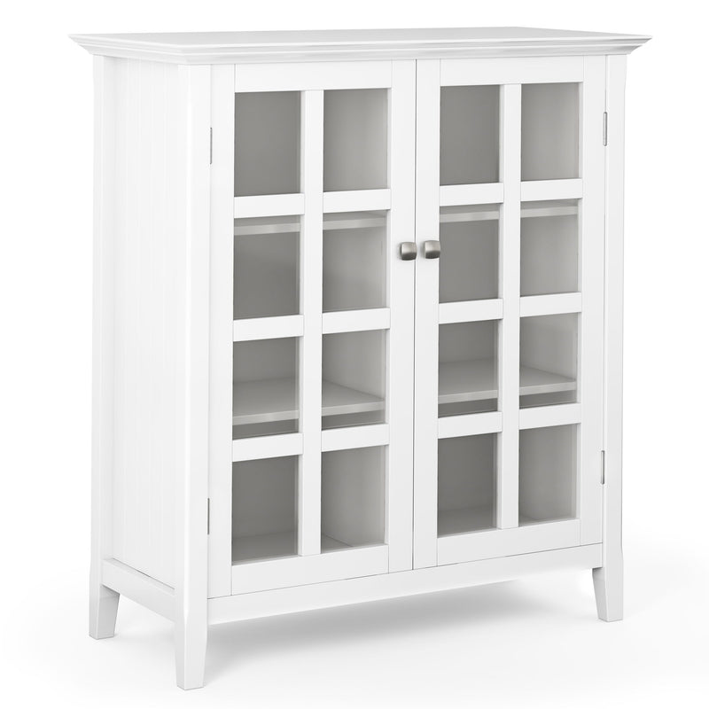 White medium storage cabinet with two glass doors, silver knobs, and multiple interior shelves.