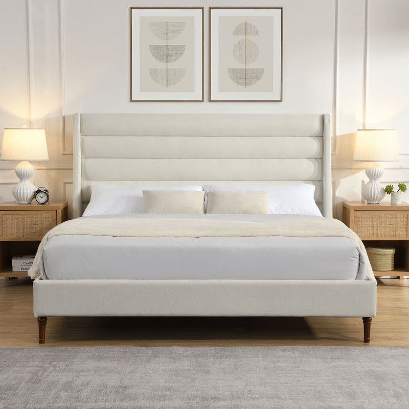 Beige upholstered platform bed with wave headboard, fitted with white bedding