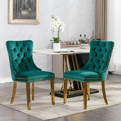 Teal button-tufted dining chairs with nailhead trim and gold-finish legs around table