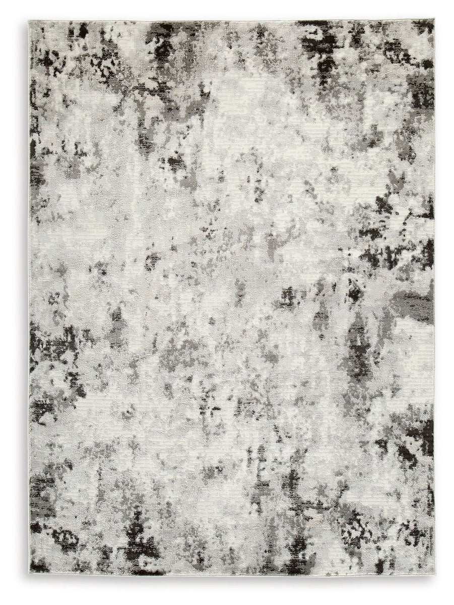 Distressed abstract area rug with light gray base and black speckled pattern