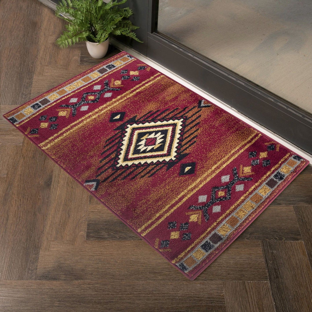 Southwest area rug with red background, central diamond medallion, and border