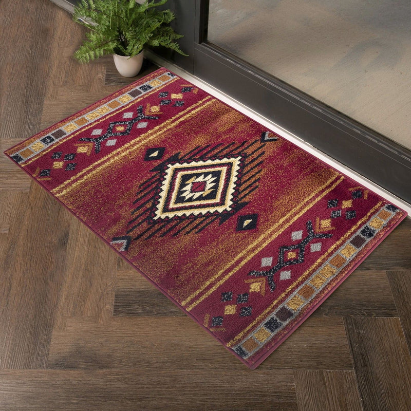 Southwest area rug with red background, central diamond medallion, and border