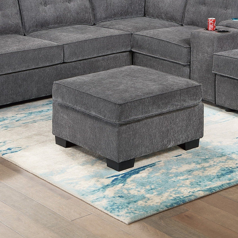 Dark gray ottoman with square top and fabric upholstery, tapered legs