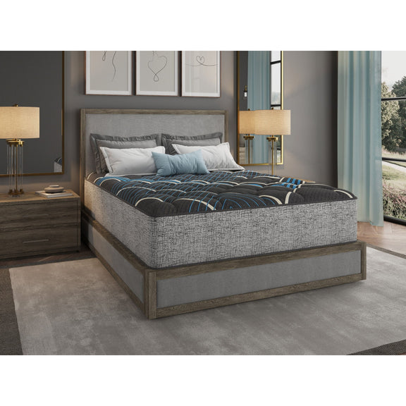 Dark gray 14-inch hybrid mattress with blue wave pattern top, shown on bed