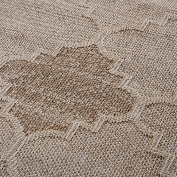 Beige trellis rug close-up with woven texture and raised geometric motifs
