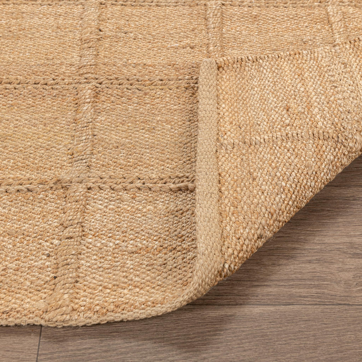 Natural jute area rug with textured surface and visible corner seam