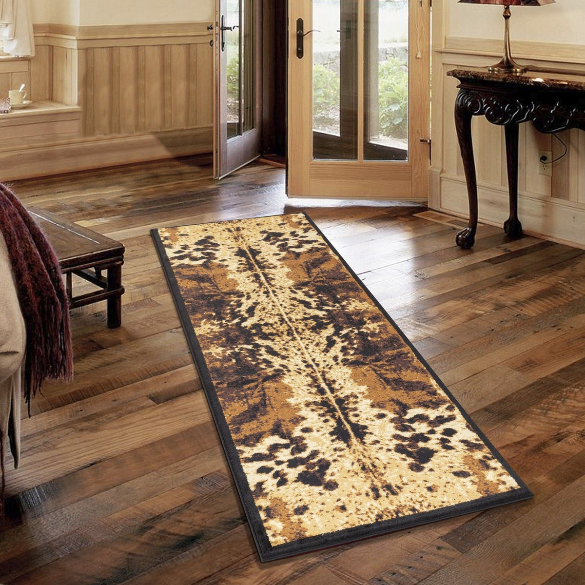 Southwest area rug runner with black edge and speckled leopard pattern, tan with dark brown.