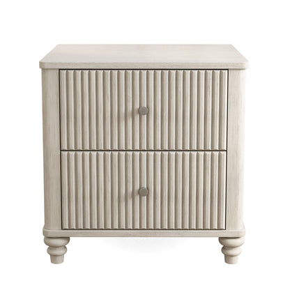 Beige fluted nightstand with 2 drawers and round metal knobs, turned legs.