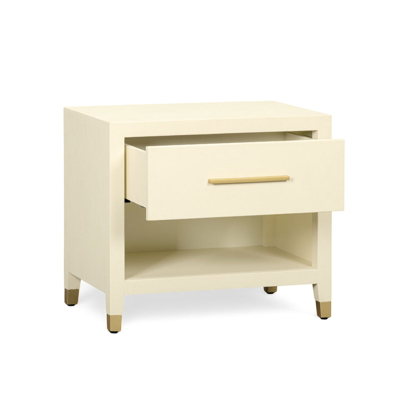 Cream nightstand with open shelf and single drawer, gold-tone bar pull, angled view.
