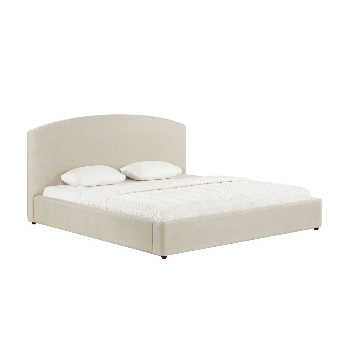 Light beige upholstered bed with curved headboard and white pillows on top